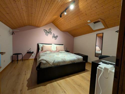 a bedroom with a bed with butterflies on the wall at B&B Lostallo Beat and Bloom in Lostallo
