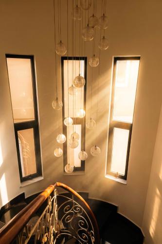 a staircase with glass balls hanging from the ceiling at Hoanglee Villa in Da Thanh