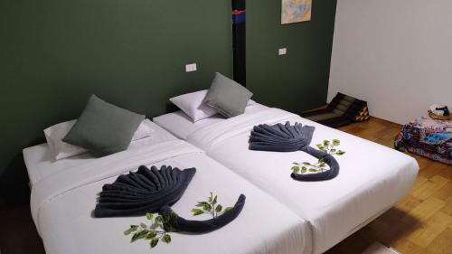 two beds in a room with black snakes on them at Laena Homestay in Ko Yao Noi