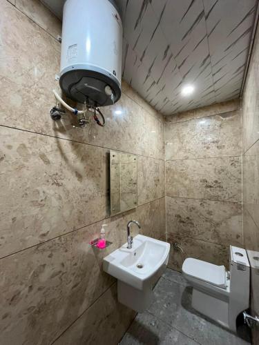 a bathroom with a sink and a toilet at Hotel Dreamland in Hisār