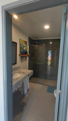 a bathroom with a sink and a toilet and a window at Casas do Pargo- Casa A - Oak Tree House in Lombada Velha