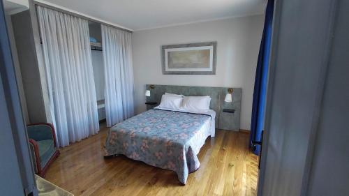 a hotel room with a bed and two windows at Casas do Pargo- Casa A - Oak Tree House in Lombada Velha