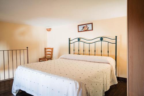 a bedroom with a bed with a white bedspread at Tenuta La Selva Casa Pendio in Casal Velino