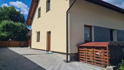 a side of a building next to a building at Apartmán Malá Valaška in Ratiboř