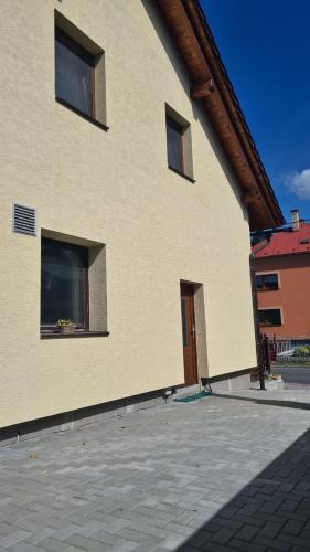 a building with two windows and a door at Apartmán Malá Valaška in Ratiboř
