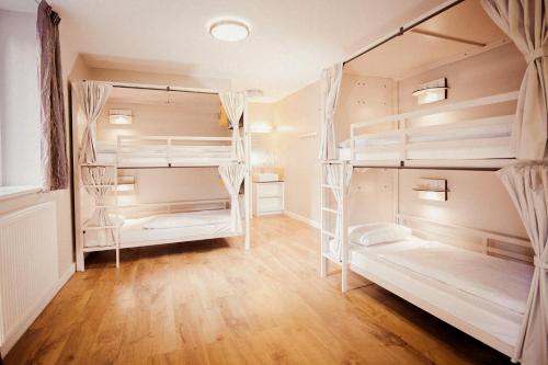 a room with four bunk beds in it at Wombat's City Hostel London in London