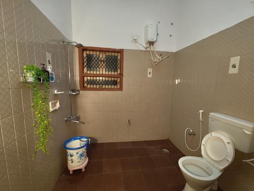 a bathroom with a toilet and a shower at Majestic Villa, 5 Bedroom AC in Mysore in Mysore