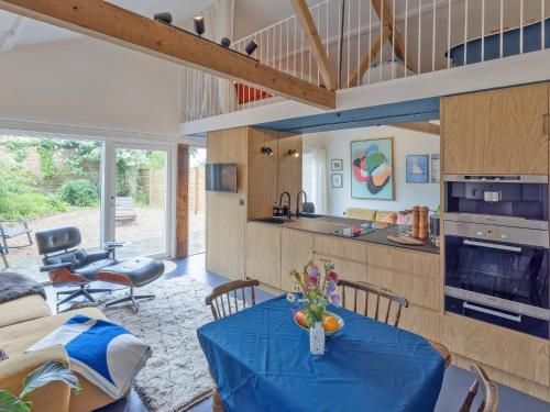 a kitchen and living room with a table and chairs at Sparrows Nest - Uk50109 in Longham
