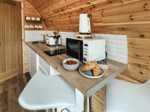 a kitchen with a counter with a microwave and some bread at Islay - Uk48416 in Dalry