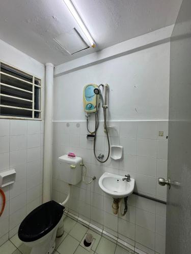 a bathroom with a toilet and a sink at Homestay PANDAN 10 PULAU MELAKA in Malacca