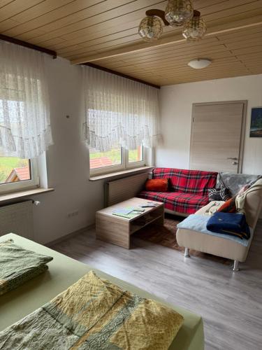 a living room with a couch and a table at Sunset BoB Fuldatal in Fulda