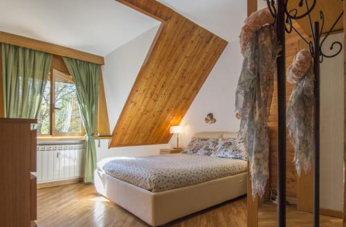a bedroom with a canopy bed and a window at Pescasseroli Appartamento Panoramico in Pescasseroli