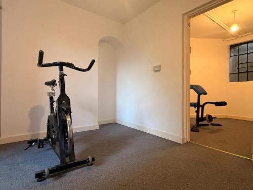 a room with a gym with a bike and weights at West View in Broughton