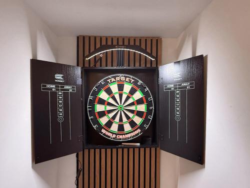 a dart board on a wall with two boxes at West View in Broughton