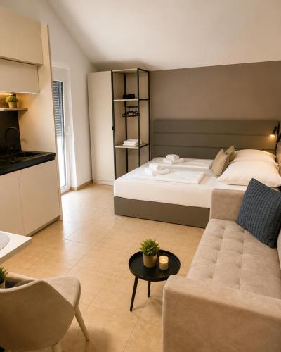 a large bedroom with a bed and a couch at Apartments Sejla in Ulcinj