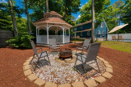 a gazebo with chairs and a fire pit in a yard at Private Pool Central AC Dog Friendly in Barnstable