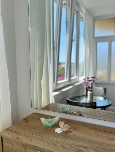 a room with a mirror and a table with star decorations at Apartman DMA in Tivat