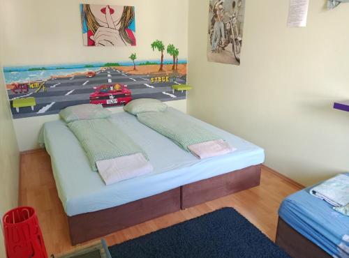a bed in a room with a painting on the wall at Ruta 80 Hostel in Brno