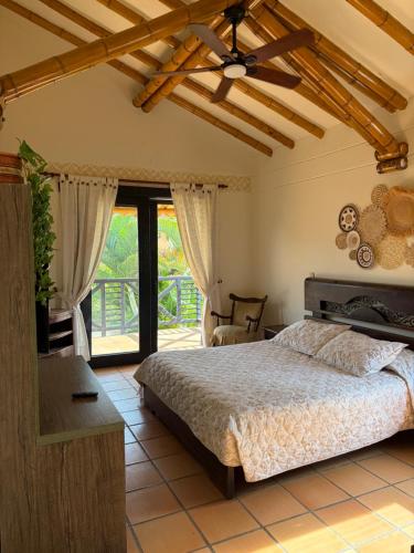 a bedroom with a bed and a large window at Casa Panaca Portal 12 in Quimbaya