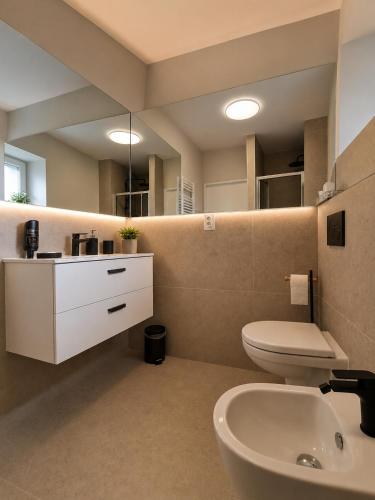 a bathroom with a toilet and a sink at Hotel Marathon in Senec