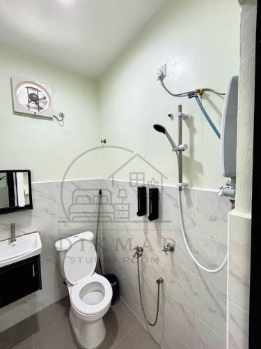 a bathroom with a shower and a toilet and a sink at Dikmad Studio Room Bukit Mentok, Kemaman in Cukai