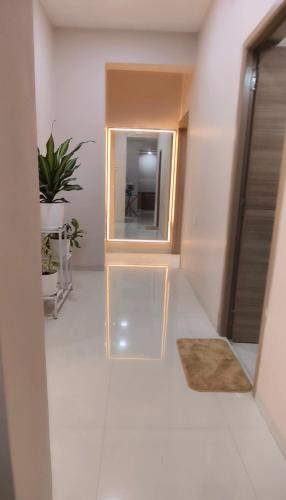 a hallway with a mirror and a rug at Sorrento Homes in Pune