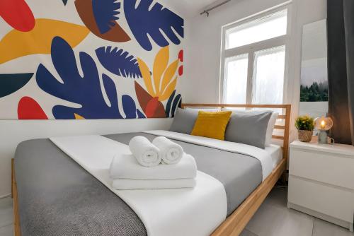a bedroom with a bed with two towels at Nature Chalet with Private Spa & Firepit in Saint-Tite-des-Caps