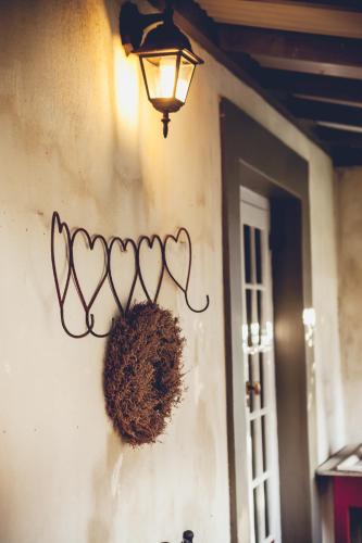 a light on the side of a wall with a basket at Station House Simondium in Simondium