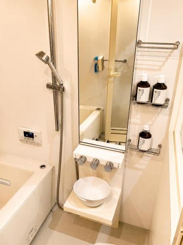 a white bathroom with a toilet and a shower at お宿 想-Oyado Sou- in Asakura