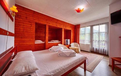 a bedroom with a large bed in a room at La Moară la Făgădău in Tuşnad