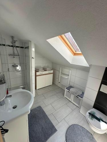 a bathroom with a sink and a skylight at Ferienwohnung Litau in Sonthofen