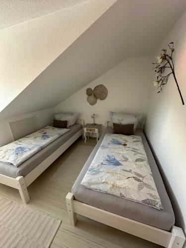 a bedroom with two beds in a attic at Ferienwohnung Litau in Sonthofen