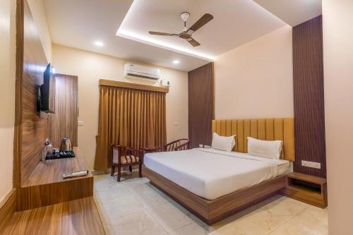 a bedroom with a bed and a television in it at Hotel Saesha International in Rāmeswaram
