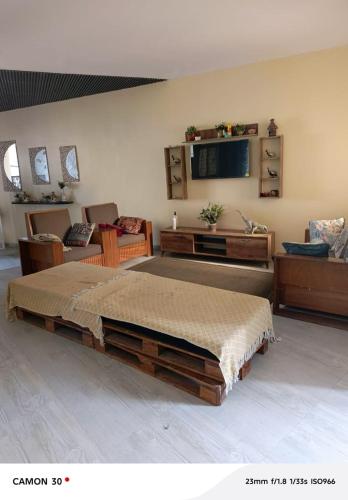 a bedroom with a large bed and a tv at Galle subalbe in Pikine