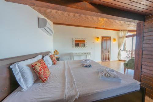 a bedroom with a large bed with white sheets and pillows at Villa Elfuze in Kalkan