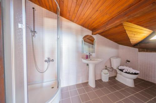 a bathroom with a shower and a sink and a toilet at Villa Elfuze in Kalkan