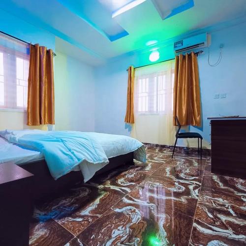 a bedroom with a bed and a blue ceiling at Wavelength Hotel and uites in Ibadan