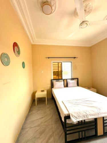 a bedroom with a large bed in a room at KMR Apartment - Sira in Sere Kunda