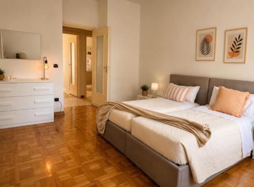 a bedroom with a large bed with pillows on it at Quick Home Victoria in Biella