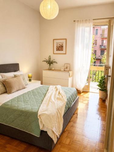 a bedroom with a large bed and a window at Quick Home Victoria in Biella