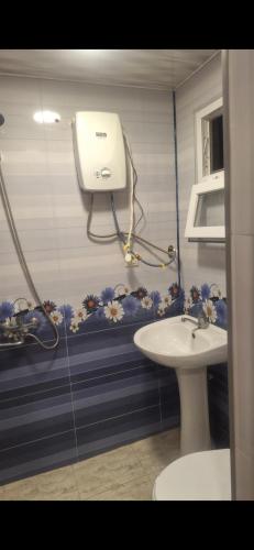 a bathroom with a toilet and a sink at Ma ry in Jvari