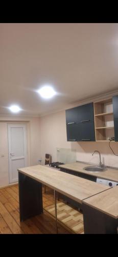 a kitchen with a wooden counter top in a room at Ma ry in Jvari