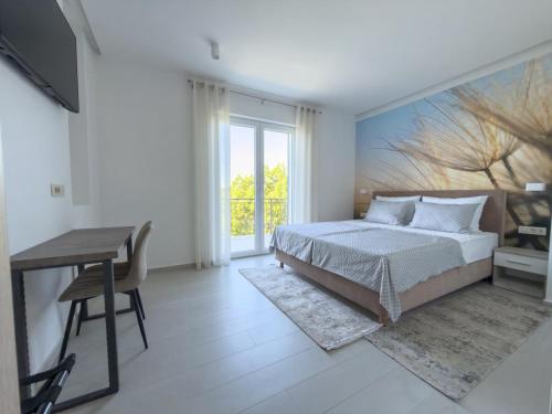 a bedroom with a bed and a desk and a window at Villa Petar Stone in Kamensko