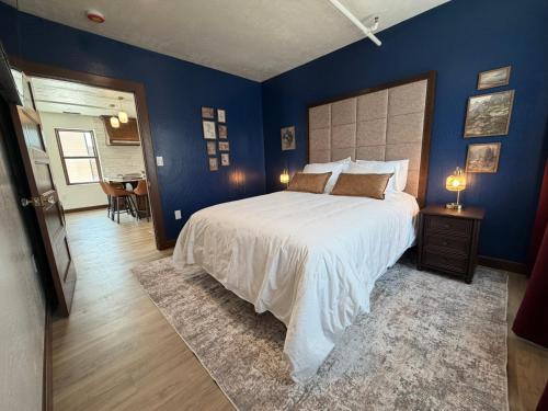 a bedroom with a large bed with blue walls at Historic Tomahawk in Green River