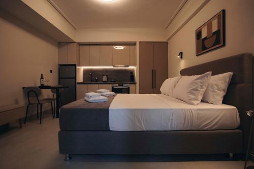 a bedroom with a large bed and a kitchen at Luna house in Chalkida