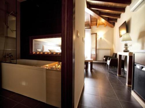 a room with a restaurant with a counter and a table at Hotel & Spa Villa de Mestas in Cangas de Onís