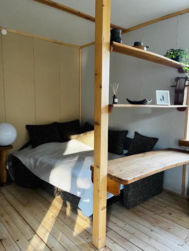 a bedroom with a bed and a wooden table at J&K Apartments in Brocēni