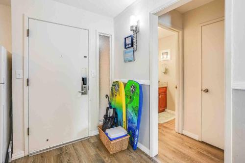 a hallway with two surfboards on the wall and a mirror at Ideal Coconut Coast Condo in Kapaa
