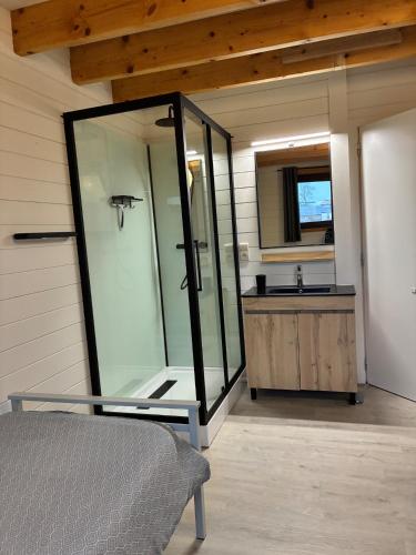 a bathroom with a tub and a sink and a mirror at MontHuit in Houffalize