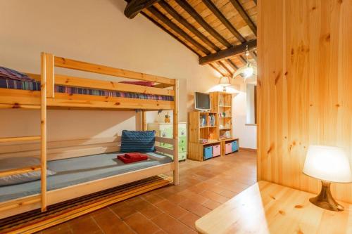 a room with two bunk beds and a lamp at Casale Bianca Luce in Santa Luce